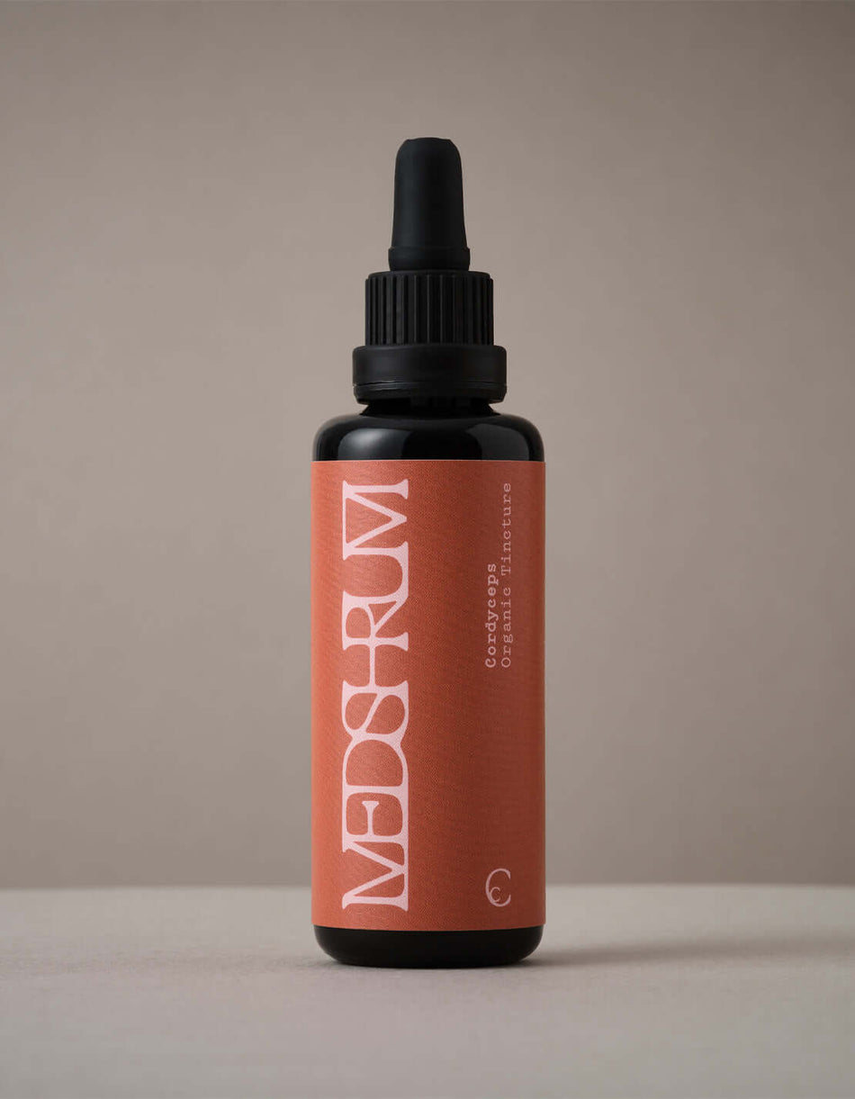Organic Cordyceps tincture by Medshrum, shown in a glass bottle with a black dropper, on a light background.