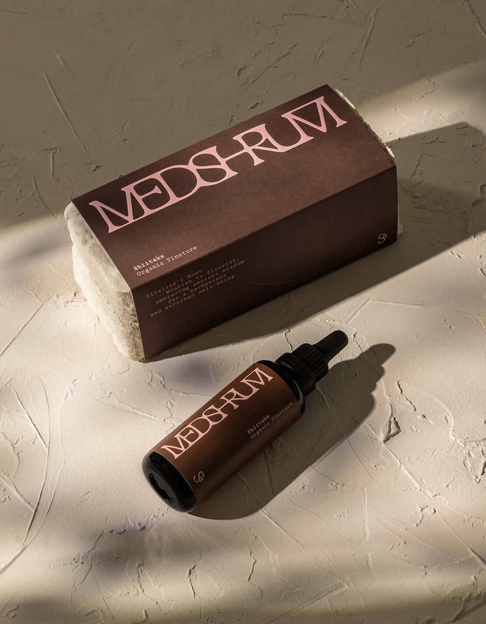 Bottle of Medshrum Shiitake Organic Tincture placed on a neutral background, showcasing the label and eco-friendly mycelium packaging.